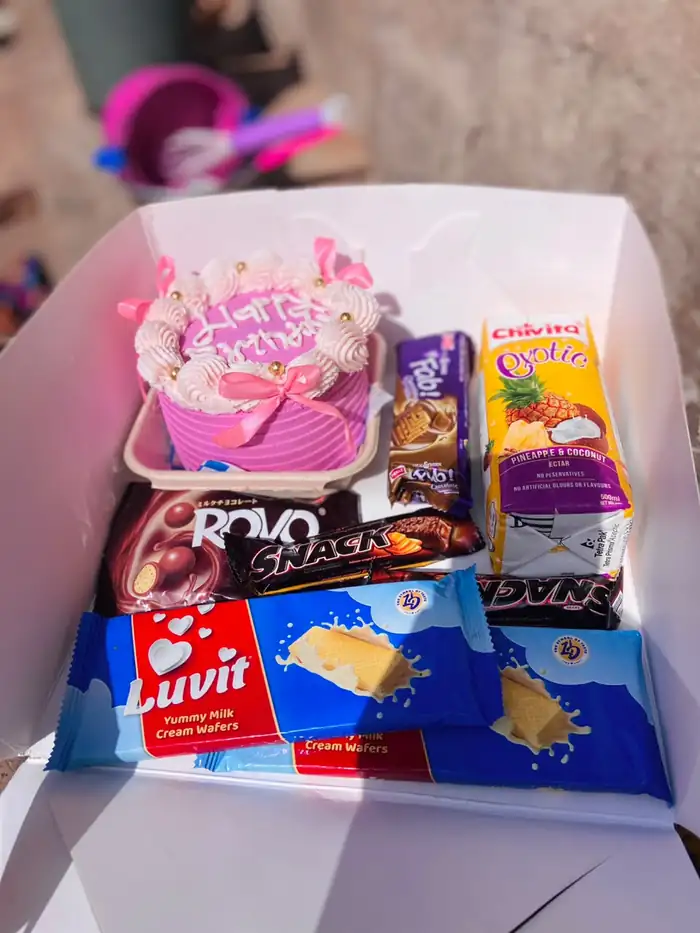 Birthday surprise box with a mini cake, chocolates, snacks and drinks