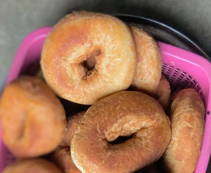 Freshly made doughnuts in a pink basket